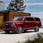 A red 2020 Chevy Suburban LT parked in a driveway.