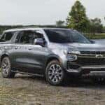 A silver 2021 Chevy Suburban Z71 is shown from the front at an angle.