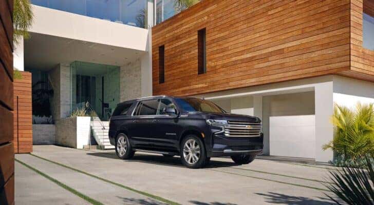 A black 2022 Chevy Suburban is shown from the front at an angle.