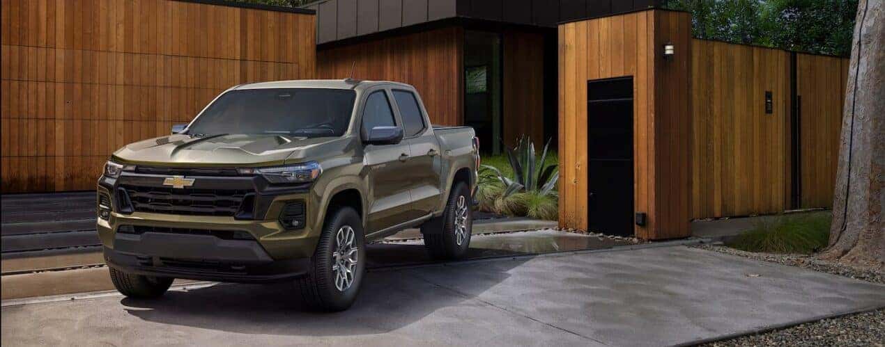 A green 2025 Chevy Colorado is shown parked on a driveway.