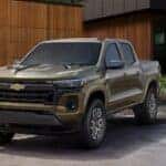 A green 2025 Chevy Colorado is shown parked on a driveway.