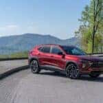 A red 2025 Chevy Trax RS is shown from the side.