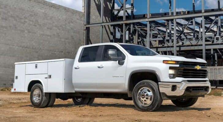A white 2024 Chevy Silverado 3500 HD is shown parked after receiving a commercial truck service.