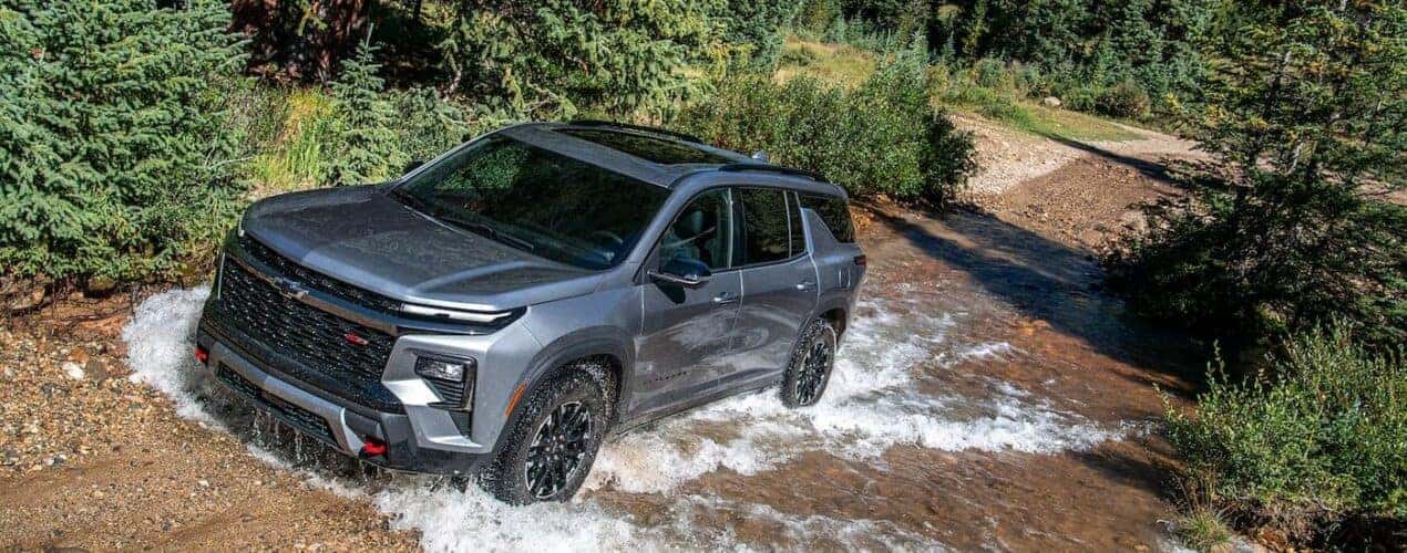 A silver 2025 Chevy Traverse Z71 is shown driving upstream.