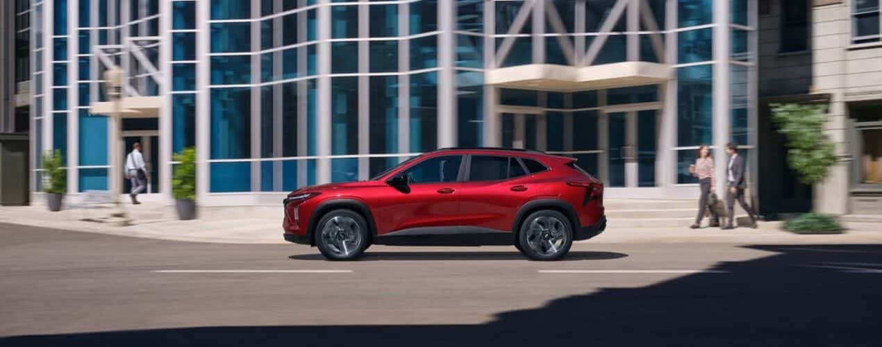 Ared 2025 Chevy Trax 2RS is shown driving on a city street.