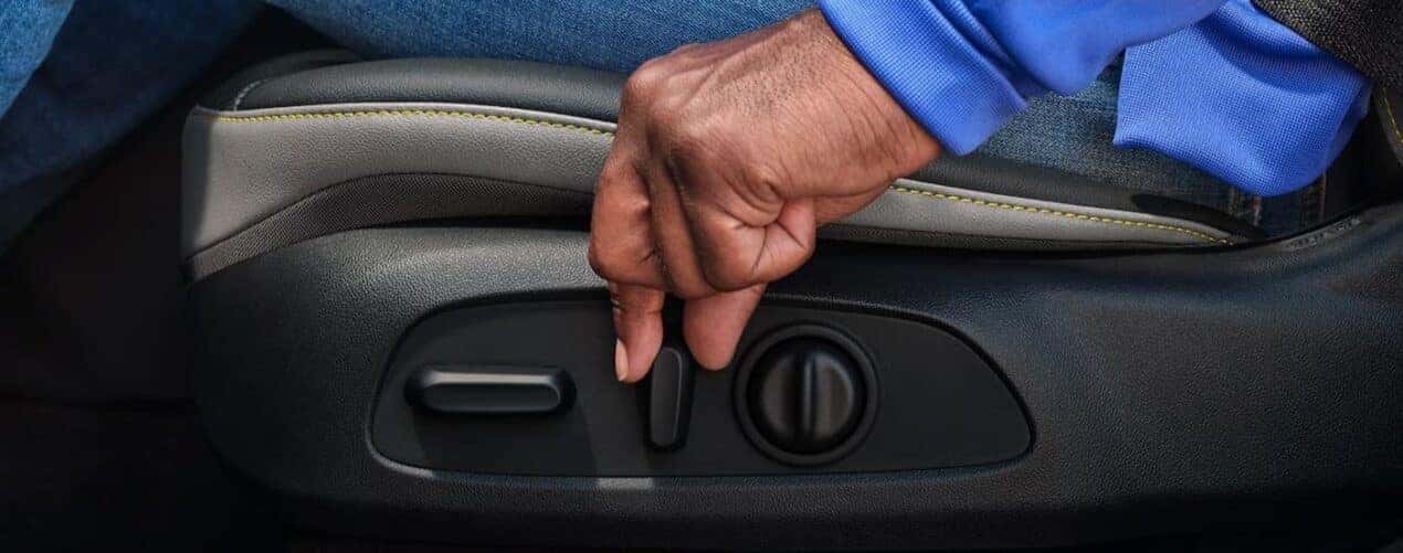 A close-up of the seat adjuster knobs are shown in a 2025 Chevy Trax LT.