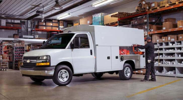 A white 2024 Chevy Express Cutaway parked in a garage after getting commercial truck service in Cincinnati.