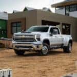 A white 2024 Chevy Silverado 3500 HD parked at a construction site.