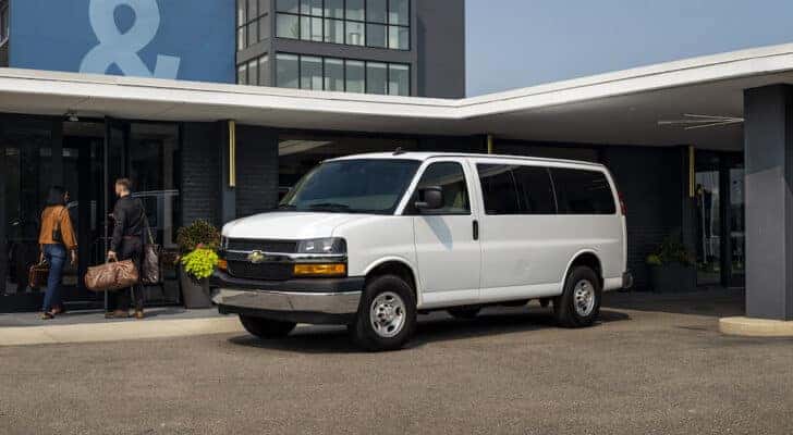 A white 2025 Chevy Express parked outside of a building after getting delivery van service in Cincinnati.