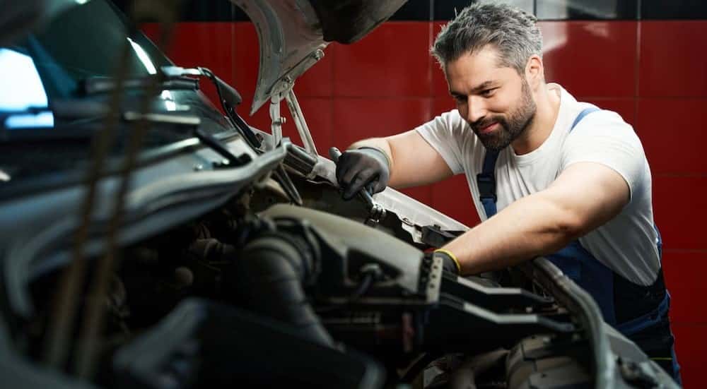 A mechanic is performing a delivery van service in Cincinnati.