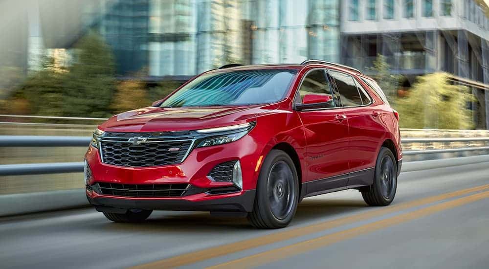 A red 2022 Chevy Equinox RS driving on a highway.