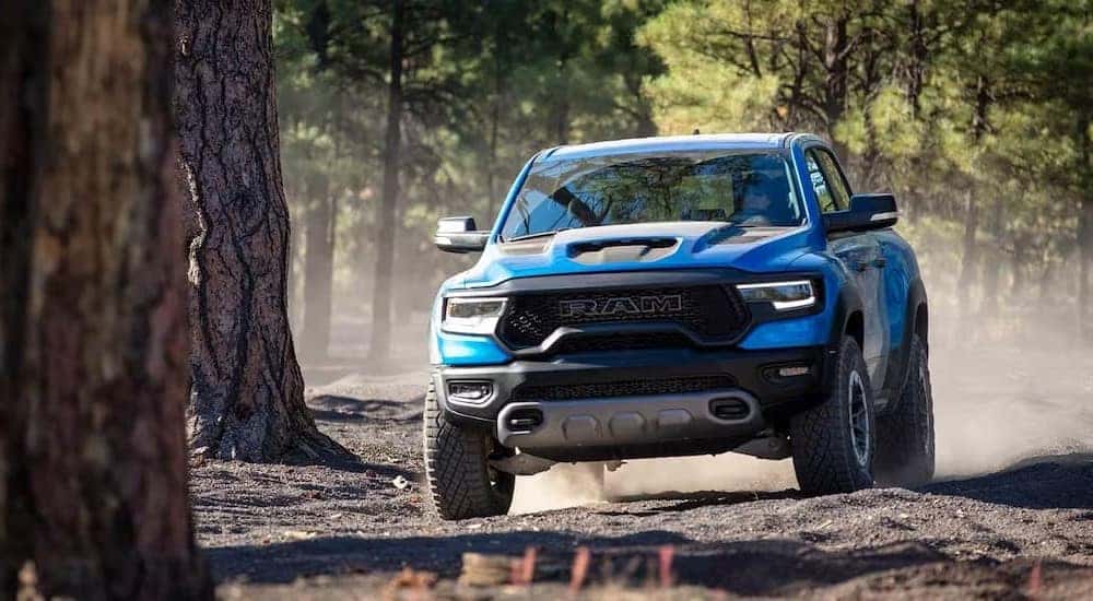 A blue 2023 Ram 1500 TRX is off-roading.