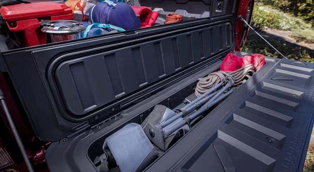 Close-up of the StowFlex tailgate on a red 2025 Chevy Colorado.