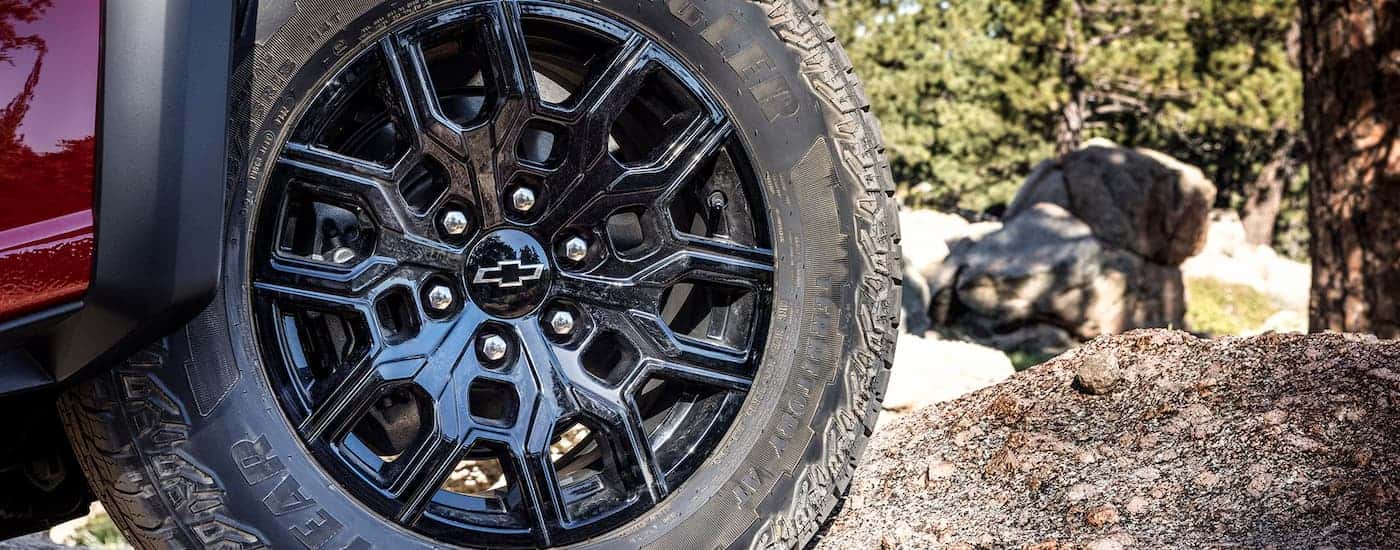 Black rim and tire on a red 2025 Chevy Colorado Trailboss.