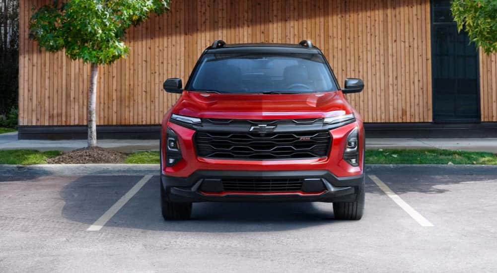 A red 2025 Chevy Equinox RS parked on a parking spot.