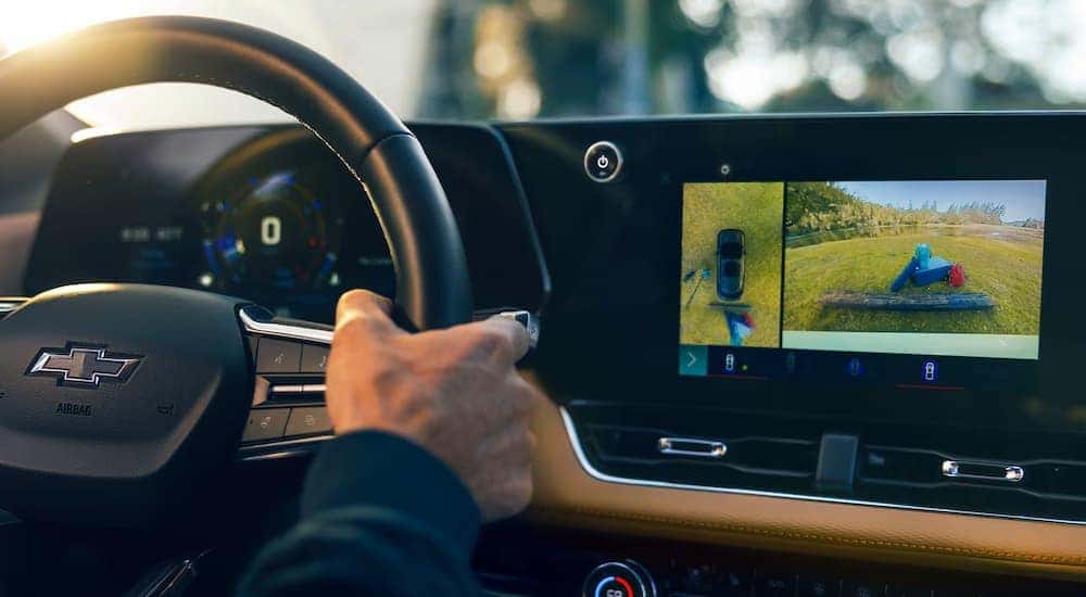 Man using the backup camera in a 2025 Chevy Equinox.