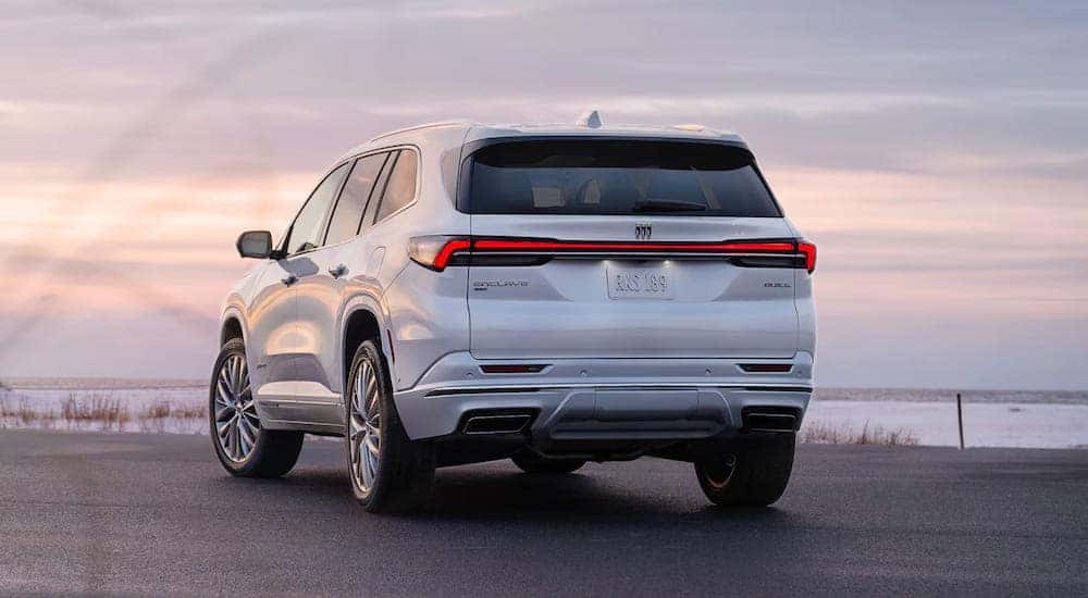 Rear view of a white 2025 Buick Enclave parked on a lot.