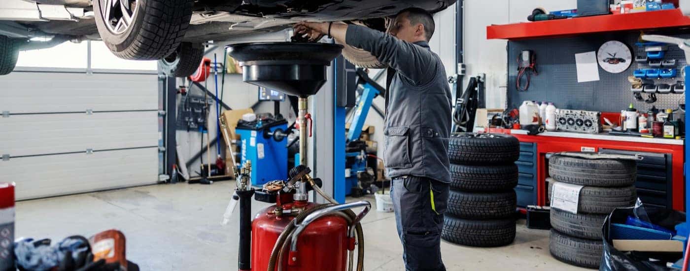 A technician performing an oil change.