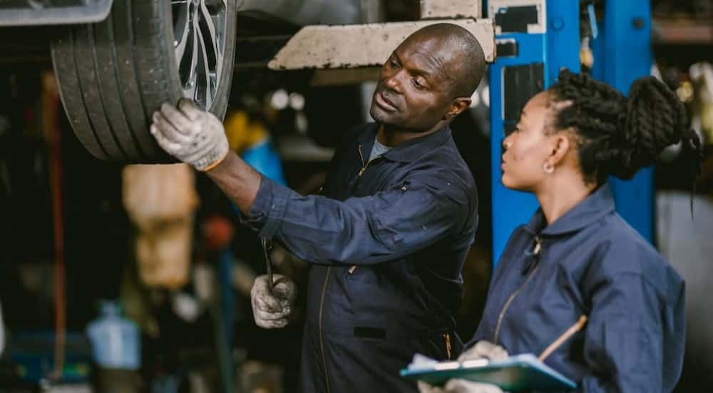 Two technicians inspecting a tire.