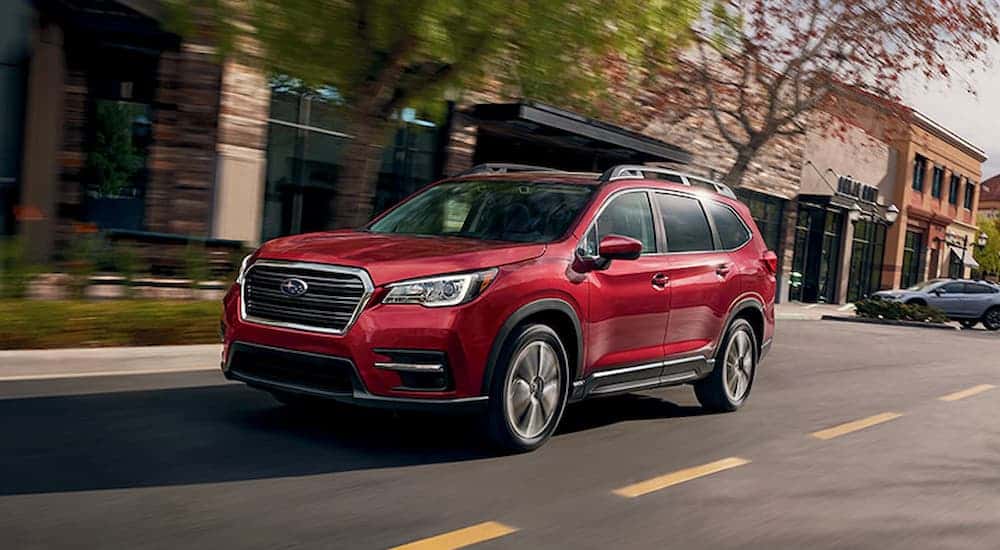 A red 2021 Subaru Ascent driving to view used cars for sale near Mason.