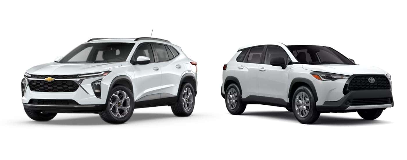 A white 2025 Chevy Trax LT vs 2025 Toyota Corolla Cross L angled right.