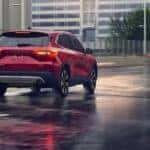 A red 2025 Ford Escape Platinum driving to a Ford service center near Florence.