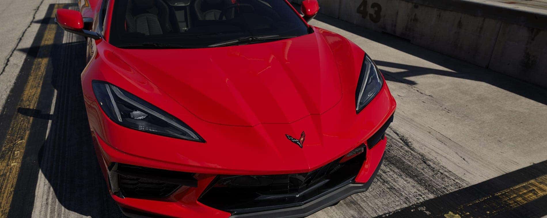 A red 2025 Chevy Corvette Stingray at a race track.
