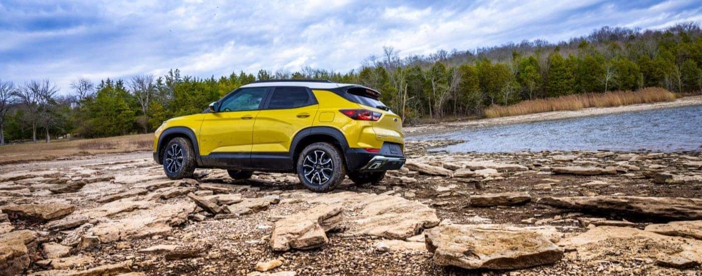 Rear view of a white 2024 Chevy Trailblazer ACTIV for sale in Cincinnati parked on a rocky coast.