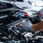 A mechanic working on an engine at a Ford service center near Florence.