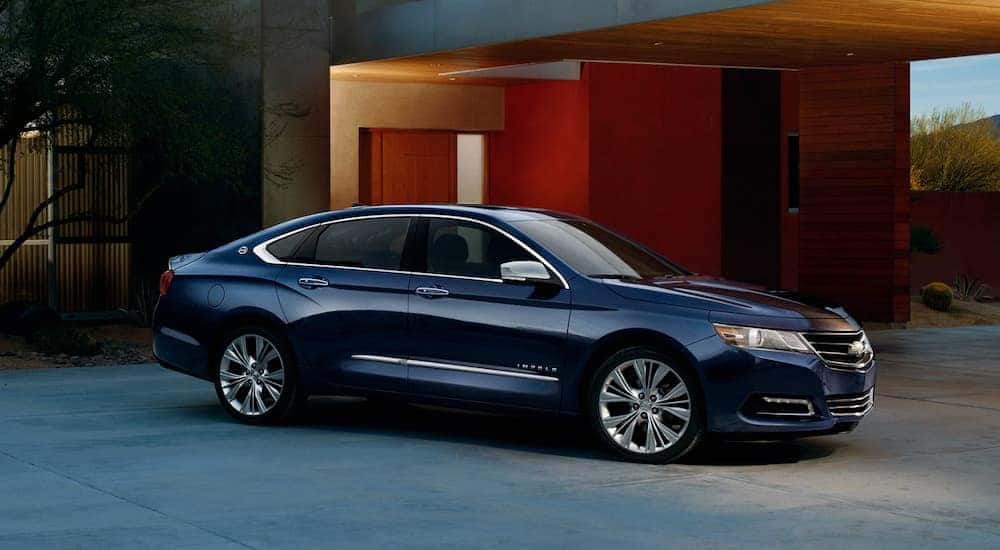 A black 2017 Chevy Impala parked on a driveway.