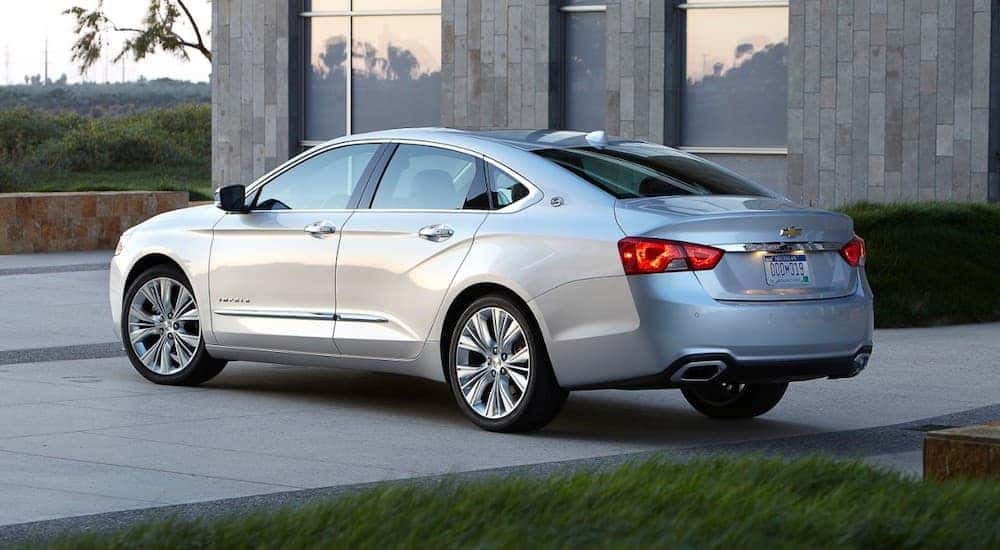 A silver 2017 Chevy Impala parked on a driveway.