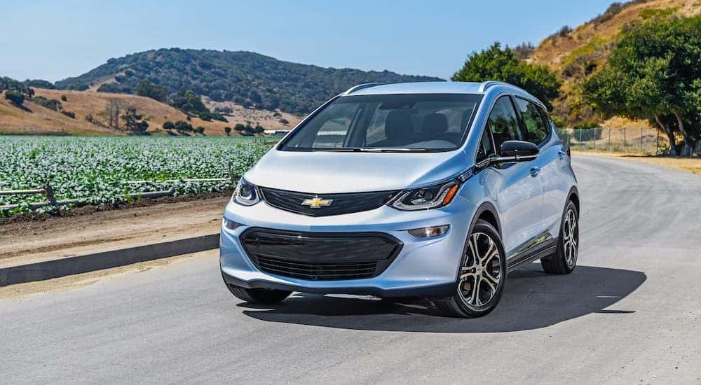 A silver 2018 Chevy Bolt parked on a backroad.