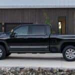 A black 2025 Chevy Silverado 2500 parked on a driveway.