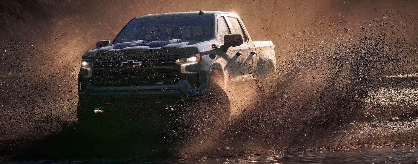 A 2025 Chevy Silverado 2500 off-roading in mud