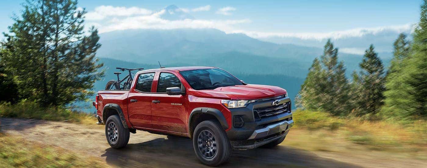 A red 2025 Chevy Colorado driving on a trail