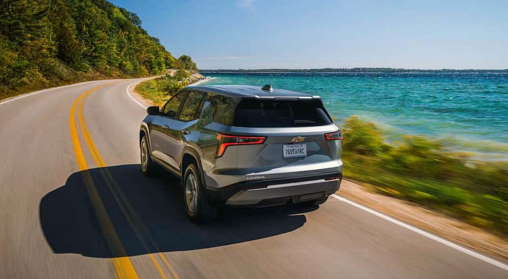A silver 2026 Chevy Equinox driving on a highway.