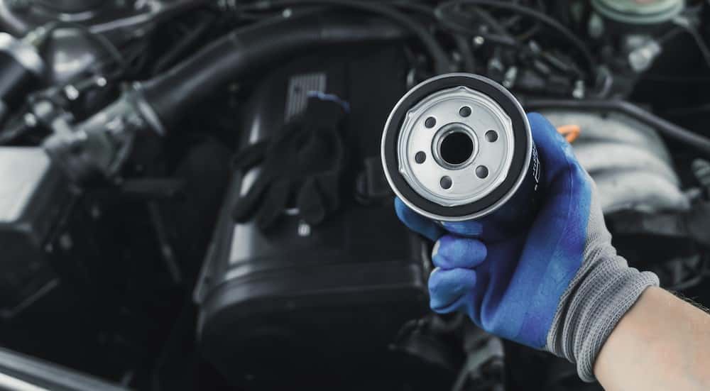 A technician holding an oil filter.