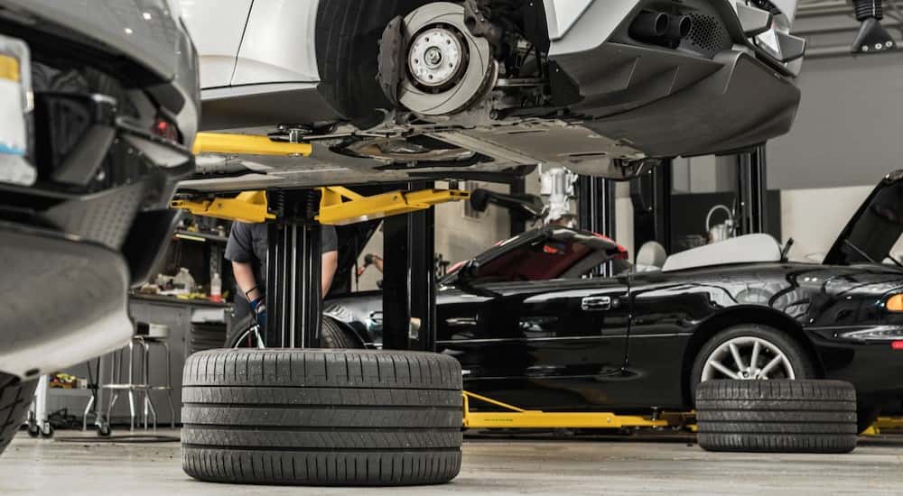 Tires laying on the floor of a garage.