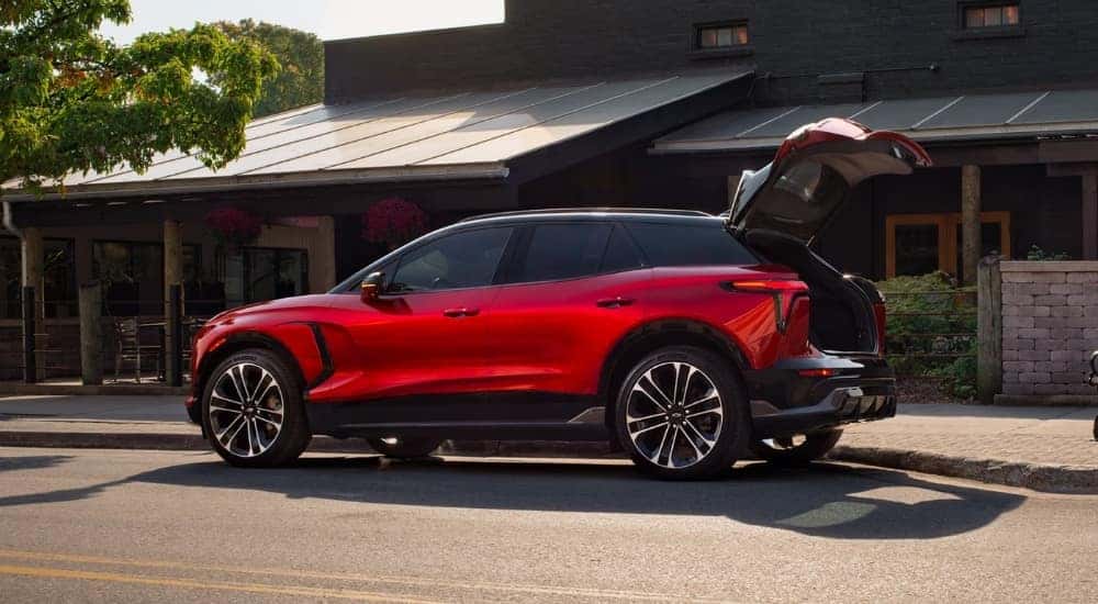A red 2025 Chevy Blazer EV SS parked in front of a building.