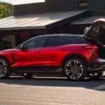 A red 2025 Chevy Blazer EV RS parked with its tailgate open.