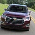A purple 2018 Chevy Traverse driving on a highway to view used cars for sale near Newport.