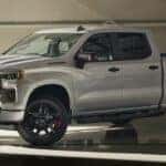 A white 2025 Chevy Silverado 1500 RST Redline Edition parked in a hangar.