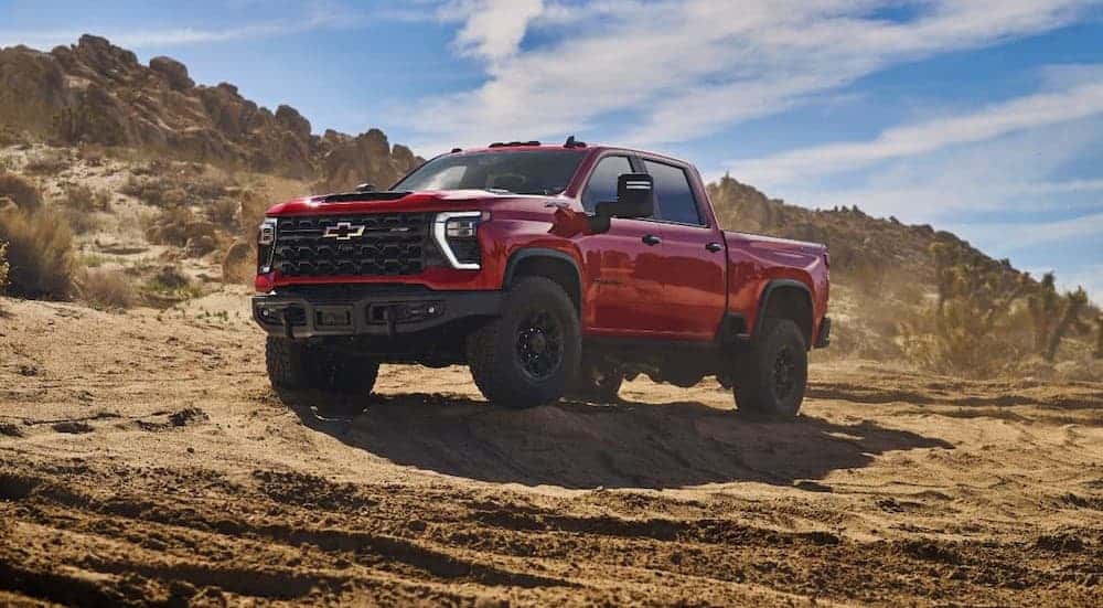 A red 2025 Chevy Silverado 1500 ZR2 Bison parked off-road.