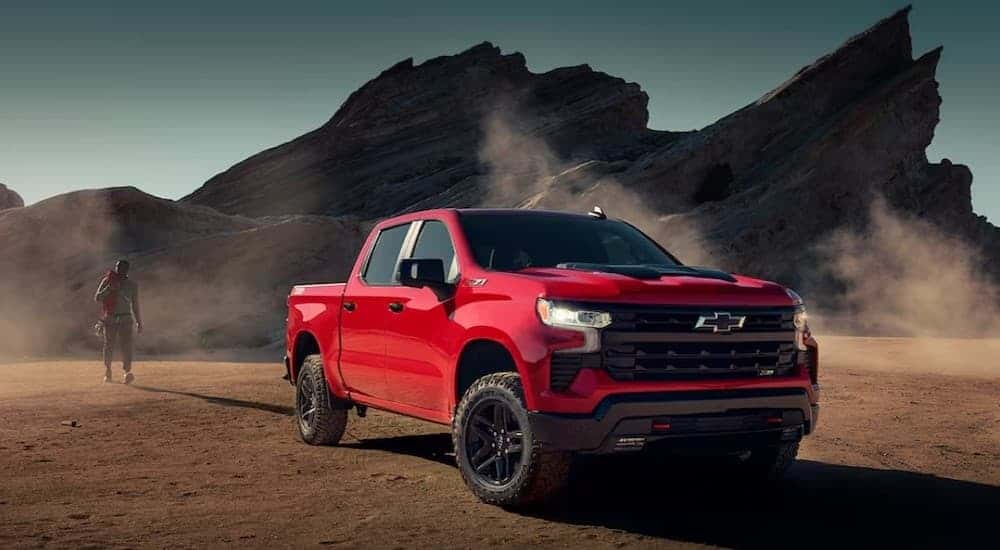 A red 2025 Chevy Silverado 1500 Z71 Trail Boss parked off-road.