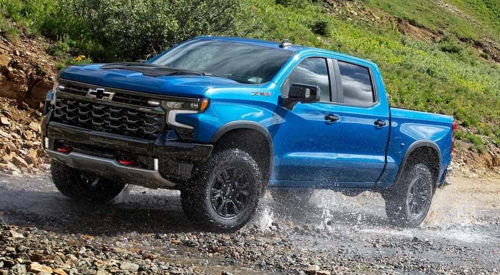 A blue 2025 Chevy Silverado 1500 ZR2 off-roading.