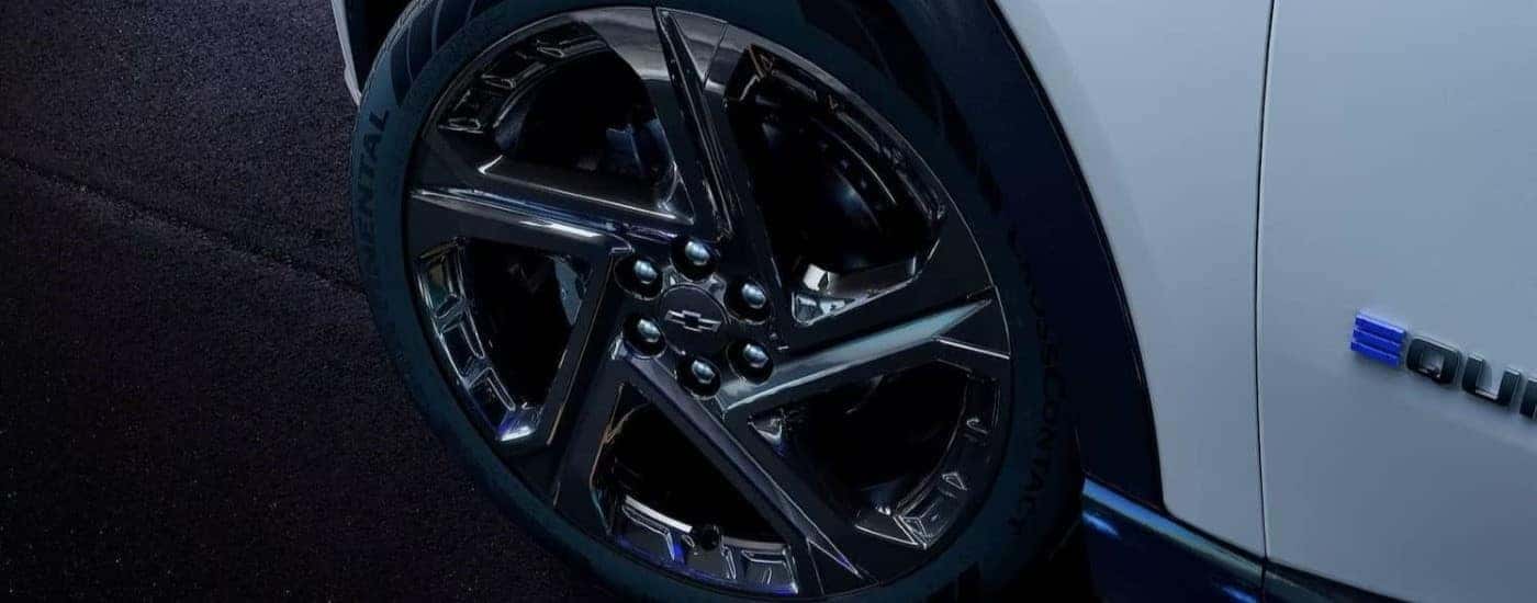 Close-up on the wheel of a white 2024 Chevy Equinox EV.