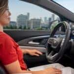 A person driving a 2025 Chevy Equinox EV for sale.