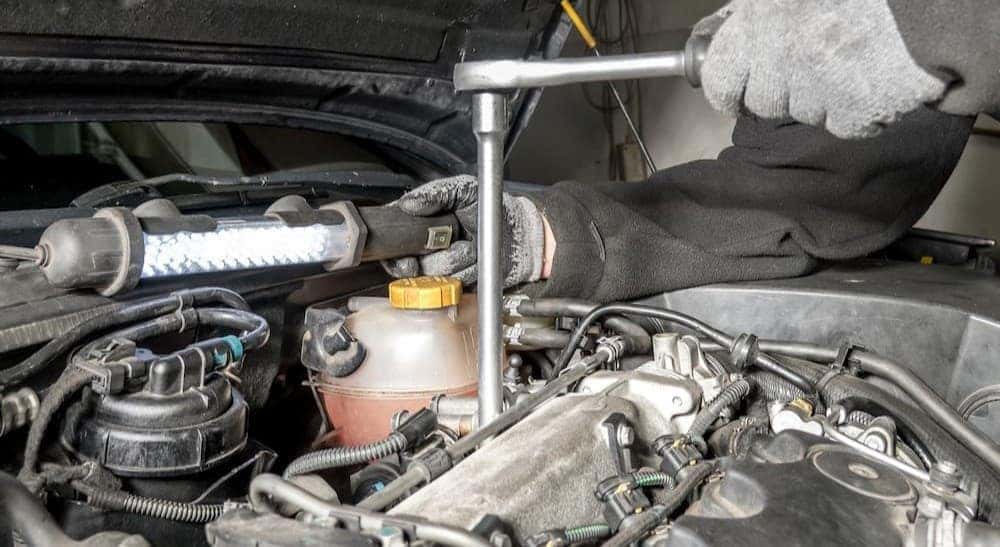 A technician working on an engine.