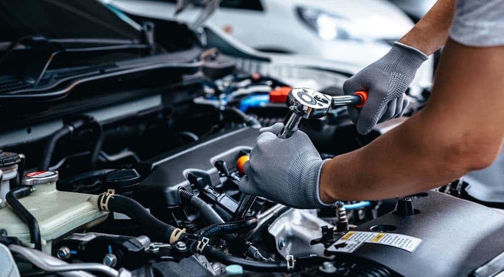 Mechanic performing repairs on the engine at a Honda service center near Covington.