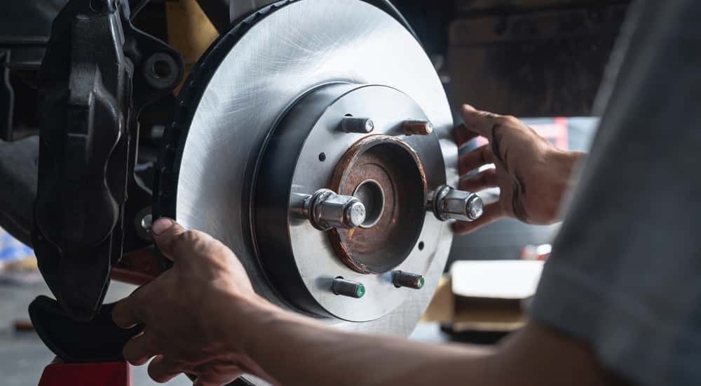 Mechanic installing a brake rotor.
